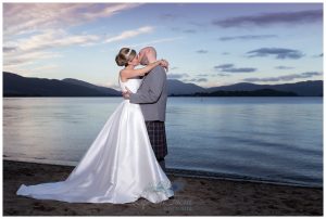 bride and groom kissing by Loch Lomond at dusk Life in Focus Portraits Wedding photographer Helensburgh Argyll and Bute