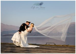bride and groon wedding photo on Luss pier Loch Lomond Life in Focus Portraits wedding photography Hlensburgh Argyll and Bute