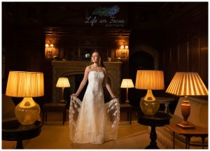 bride in castle surrounded by antique lamps Life in Focus Portraits scottish castle wedding photography Loch Lomond