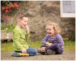 brother and sister playing and laughing farm holiday cottage luss Life in Focus Portraits family vacation photographer Loch Lomond and Trossachs national park Scotland
