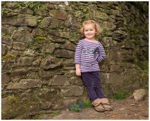 girl leaning against wall on farm holiday cottage Luss Loch Lomond Life in Focus Portraits family vacation photography Loch Lomond Scotland