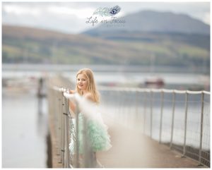 girl on pier with loch and mountains Life in Focus Portraits Helensburgh child photographer Rhu Gareloch