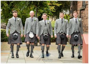 groom and grromsmen in kilts outsideSt PAtricks Church Dumbarton Scottish wedding Life in Focus Portraits wedding photographer