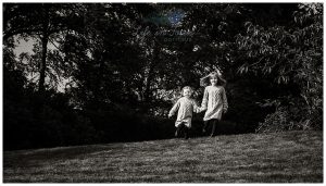 monochrome photo of children running in park outdoor location photoshoot Life in Focus Portraits child photographer Dumbarton