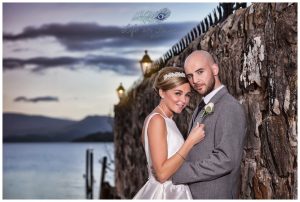 newly married bride and groom by Loch Lomond at sunset Life in Focus Portraits wedding photos Helensburgh Argyll and Bute
