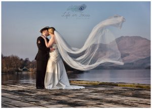 wedding photo Royal Navy married couple on Luss pier with Ben Lomond as natures backdrop Life in Focus Portraits wedding photographer Loch Lomond