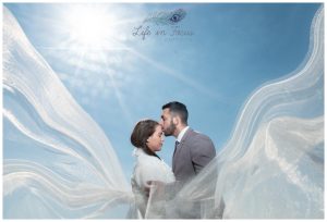 wedding photo bride and groom with veil and sun flare Life in Focus Portraits destination wedding photographer Loch Lomond Argyll and Bute