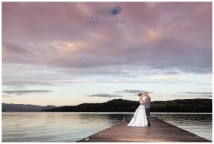 wedding photo newly married bride and groom on pier at Duck Bay Hotel at sunset Life in Focus Portraits wedding photographer Helensburgh Loch Lomond