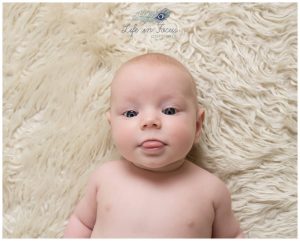 4 month old baby poking tongue out at photographer Life in Focus Portraits newborn baby photographer Rhu Helensburgh Cardross