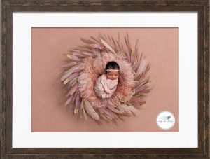 Framed photo of newborn photoshopped into feather background Life in Focus Portraits newbonr baby photography Rhu Helensburgh Roseneath