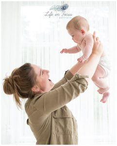 Mum ligting baby into air Life in Focus Portraits baby photography Helesburgh Luss Arrochar