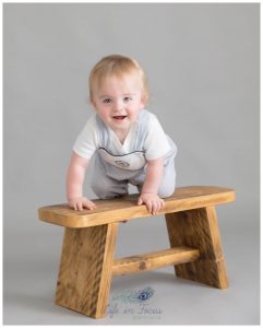 baby boy climbing on bench 1st Birthday milestone Life in Focus Portriats baby photographer Cardross