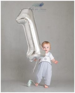 baby boy with huge number one balloon first birthday photos hoot Life in Focus Portraits Rhu baby photography studio Helensburgh