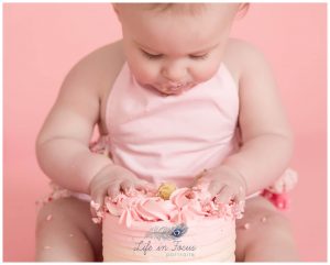 baby girl playing with first Birthday cake Life in Focus Portraits Rhu baby photographer Helensburgh Argyll and Bute