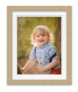 photo of little boy smiling at photographer Life in Focus Portraits family outdoor photoshootss Helensburgh