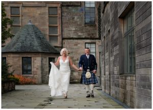 Wedding photo of bride and groom walking outside Helensburgh Civic Centre Argyll and Bute Elopement Wedding