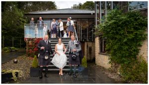 photo of bride holding up dress to walk down stairs at Lodge on Loch Lomond wedding venue