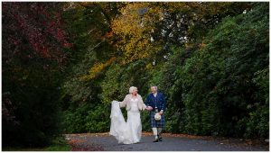 wedding photo Bride and Groom amidst Autumn colours secret micro Wedding Rhu Helensburgh