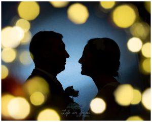 silhouette photo of bride and groom surrounded by fairy lights Loch Lomond wedding