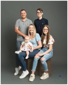 photo of family in photography studio on gray backdrop Rhu Photography studio